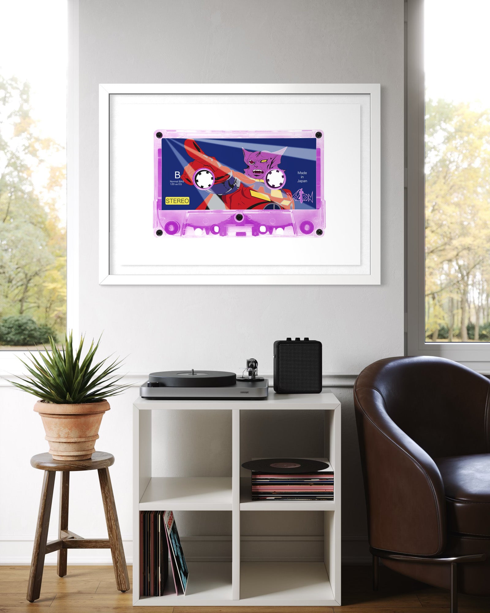 Framed artwork of a cassette tape on a wall above a turntable and records.